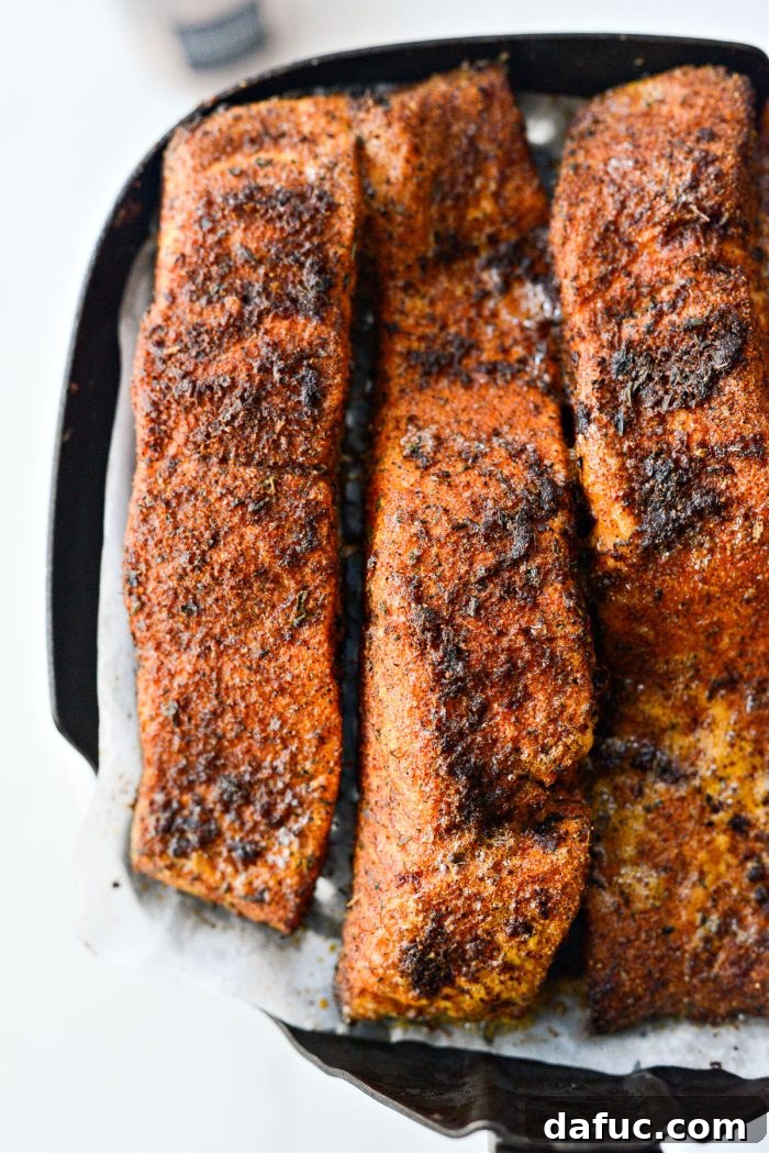 Perfectly air-fried blackened salmon fillets with a crispy crust in the air fryer basket