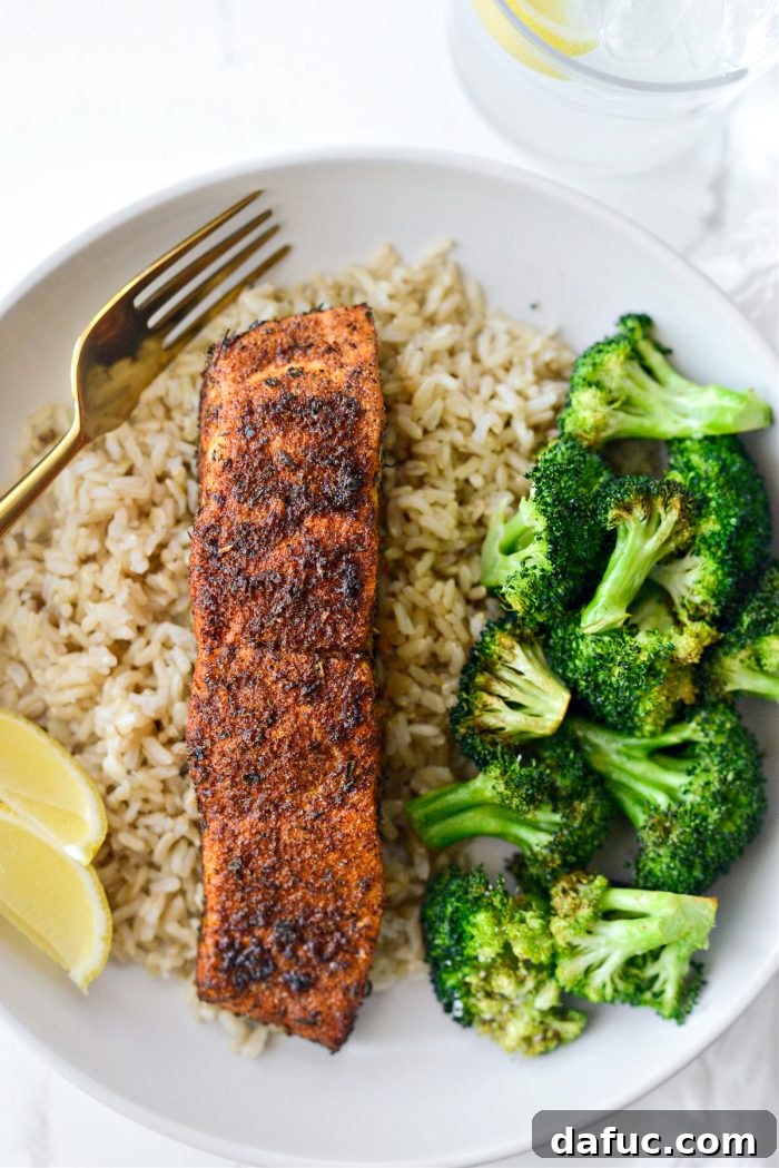 Crispy Air-Fried Blackened Salmon 12 Close-up of a finished Air Fryer Blackened Salmon dish, garnished with herbs and lemon
