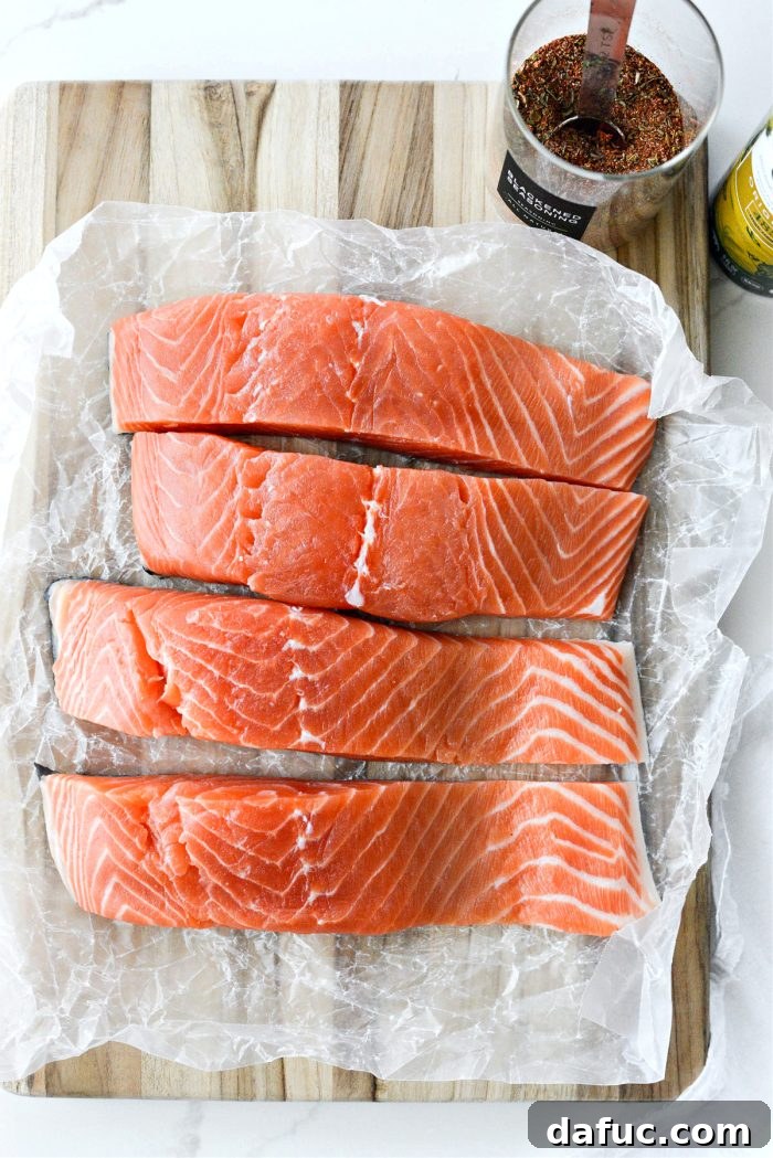 Crispy Air-Fried Blackened Salmon 4 Ingredients laid out for Air Fryer Blackened Salmon: salmon, ghee oil spray, and blackened seasoning