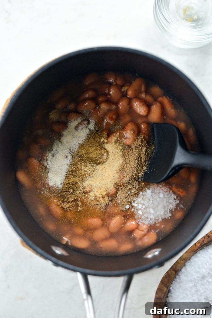 Skinny Refried Beans 4 beans, some bean liquid and spices in pan or skillet