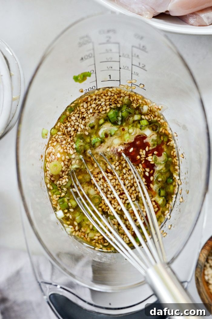 Savory Sesame Grilled Chicken Noodle Bowls 6 Whisking the sesame chicken marinade in a bowl, showing the rich, savory texture