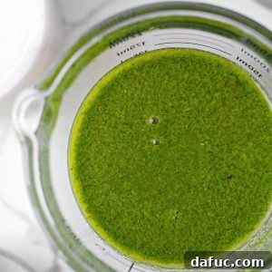 Effortless Fresh Basil Oil 10 Basil Oil in a small bowl with basil leaves