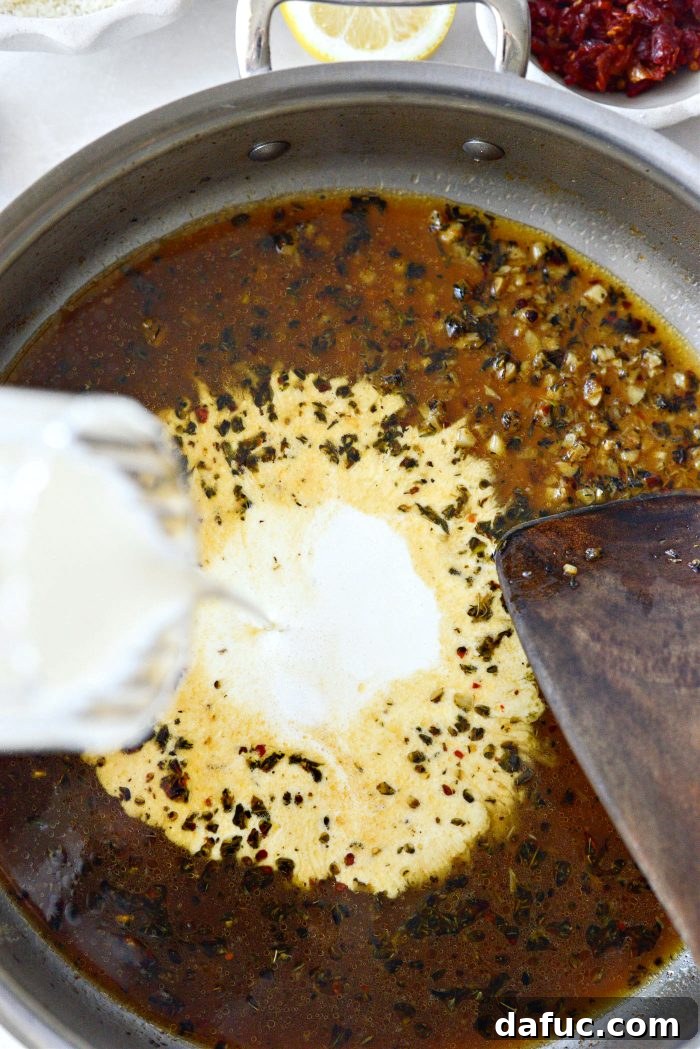 The I Do Chicken 14 Pouring rich heavy cream into the simmering sauce mixture