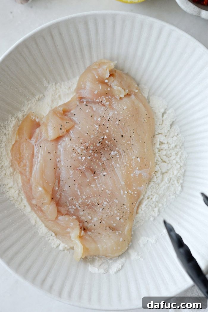 The I Do Chicken 7 Dredging chicken breasts in flour for Marry Me Chicken