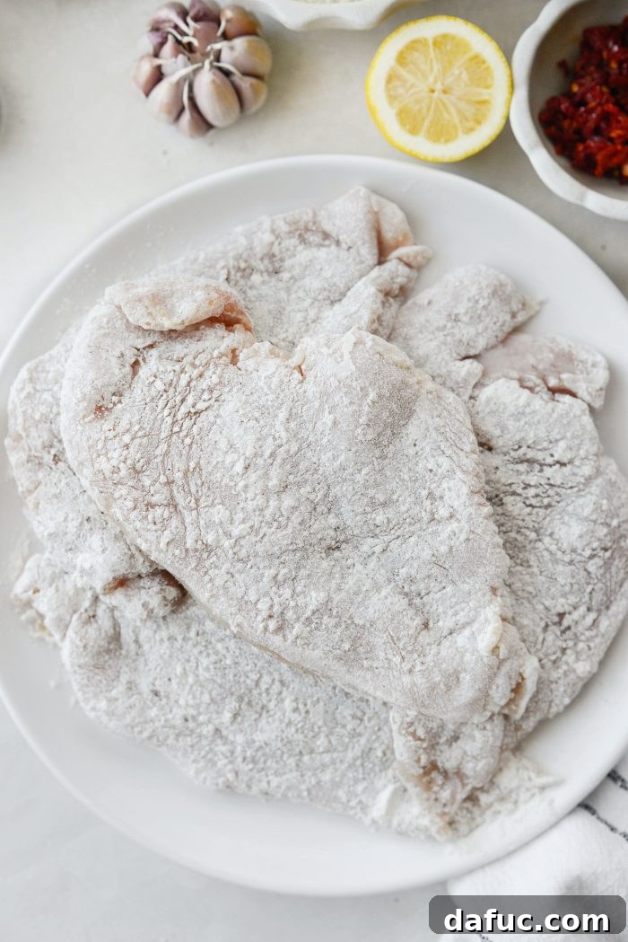 The I Do Chicken 8 Floured chicken breasts resting on a plate before searing