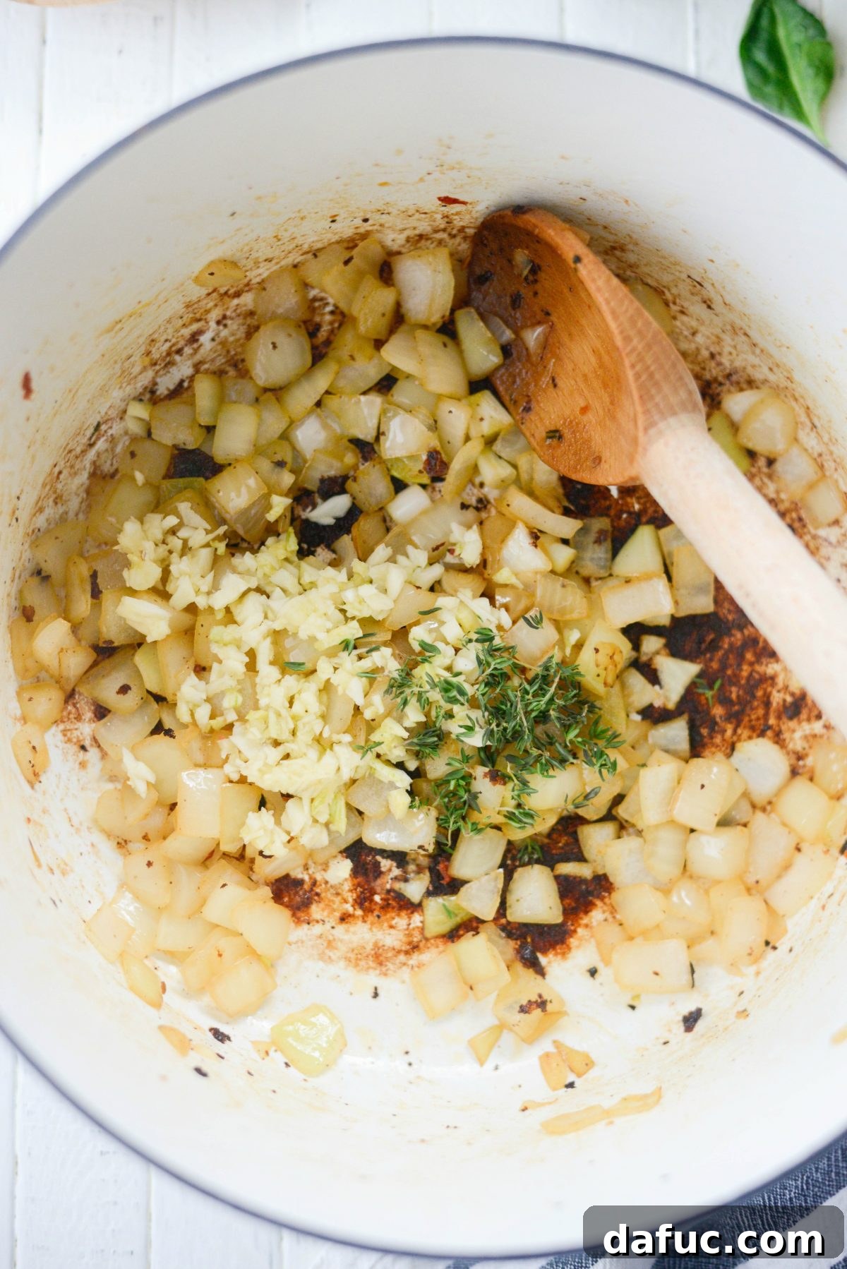 Rustic Chicken Sausage and White Bean Pot 7 Minced garlic and fresh thyme leaves added to softened onions