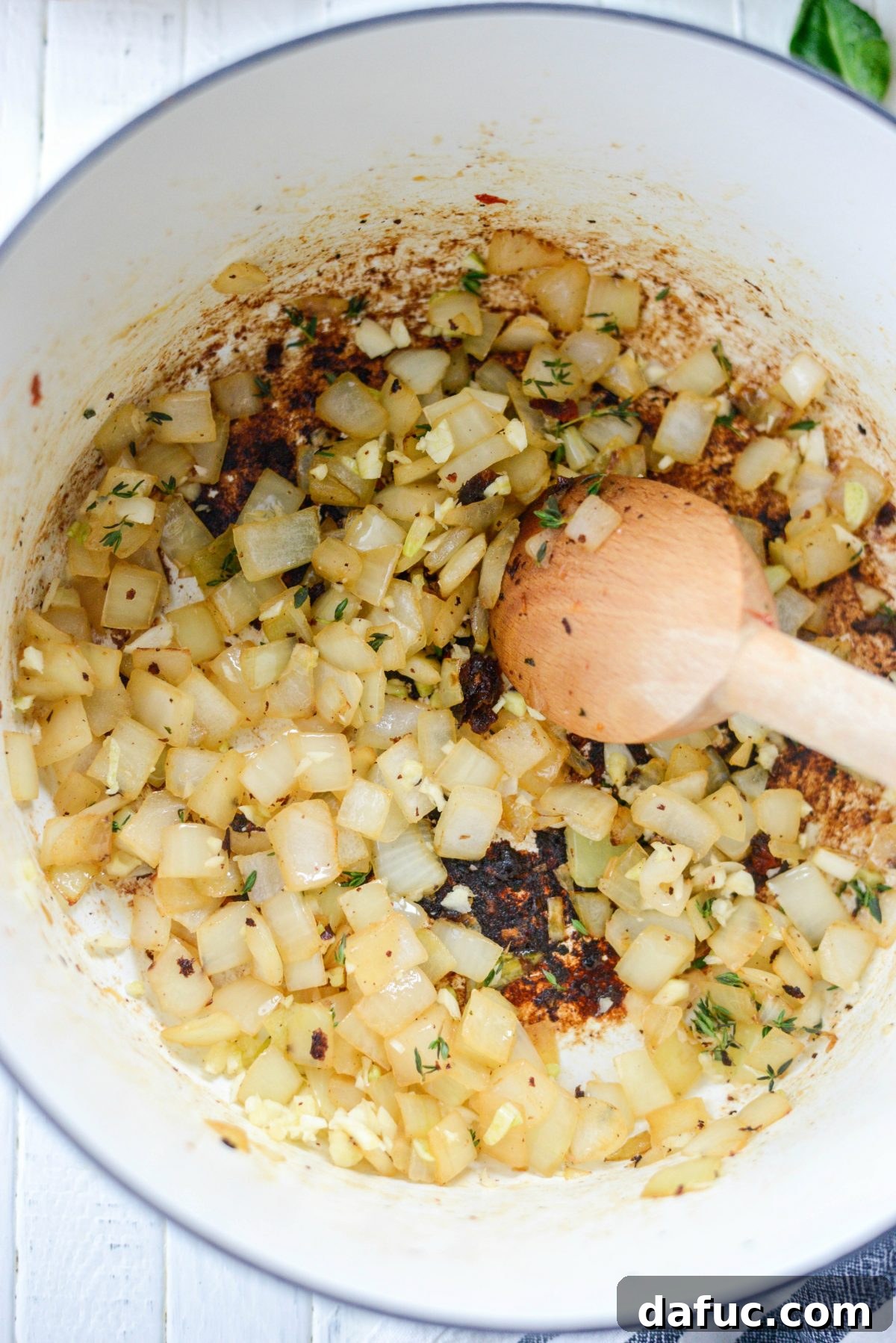 Rustic Chicken Sausage and White Bean Pot 8 Garlic and thyme simmering with onions in the pot
