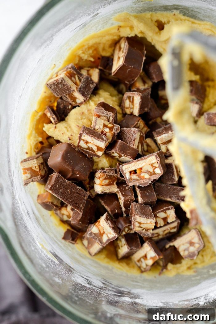 Chopped Snickers added to cookie dough