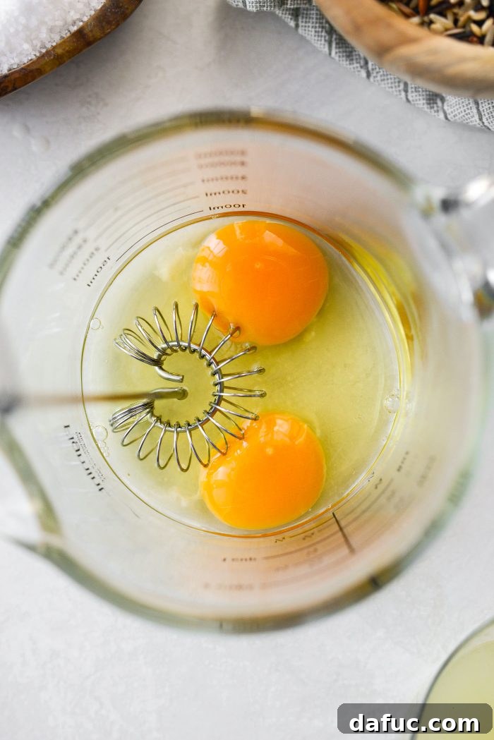 Beating eggs in a measuring cup for tempering.
