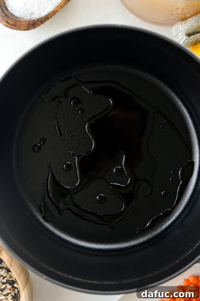 Heating olive oil in a Dutch oven for soup.