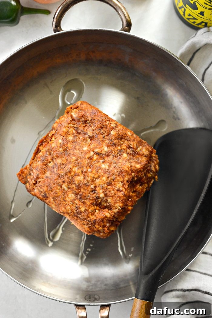 Avocado oil and ground chorizo in a skillet