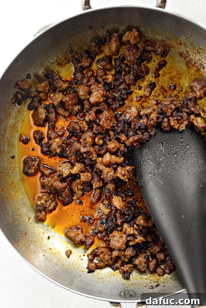 Breaking up ground chorizo in a skillet as it cooks