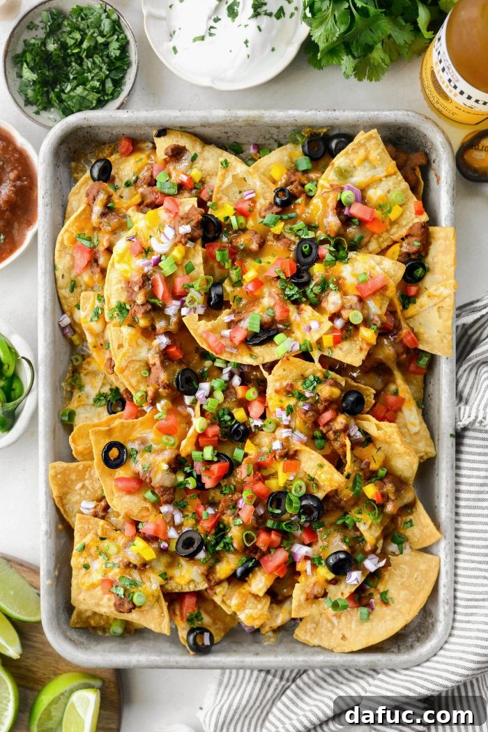 Ultimate Beef and Bean Nachos 15 once baked, top with tomatoes, green onions and cilantro
