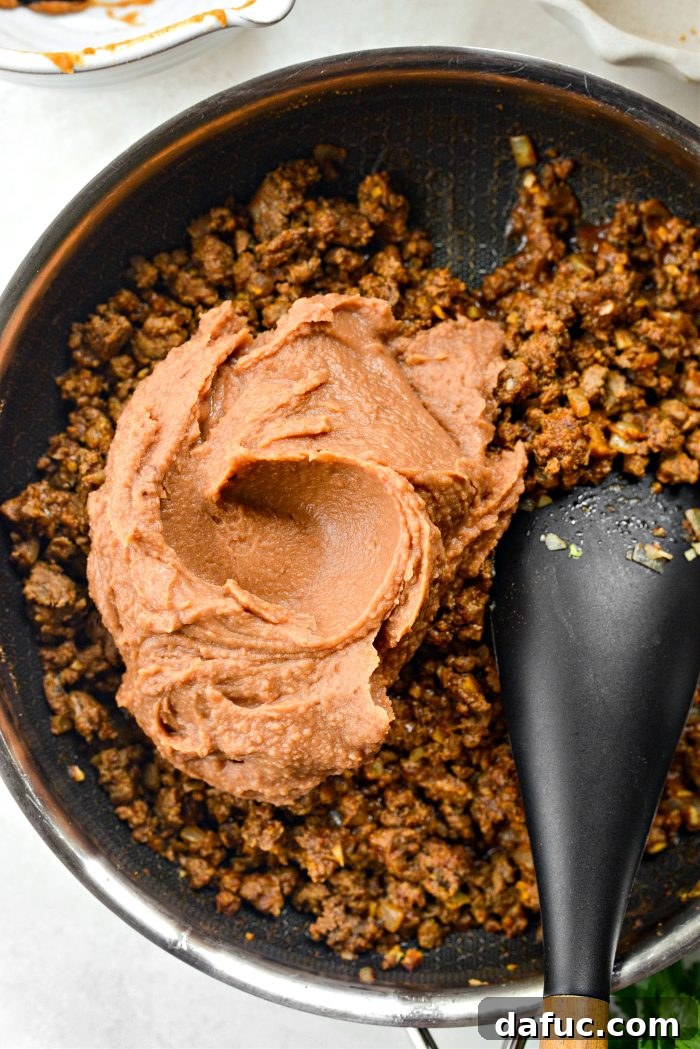 Ultimate Beef and Bean Nachos 10 add in refried beans