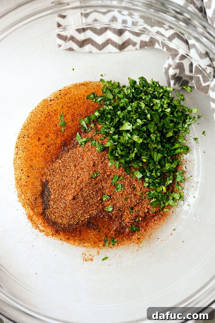 Smoky Chicken Elote Bowls 11 Avocado oil, lime juice, street taco seasoning, and cilantro in a mixing bowl for chicken marinade