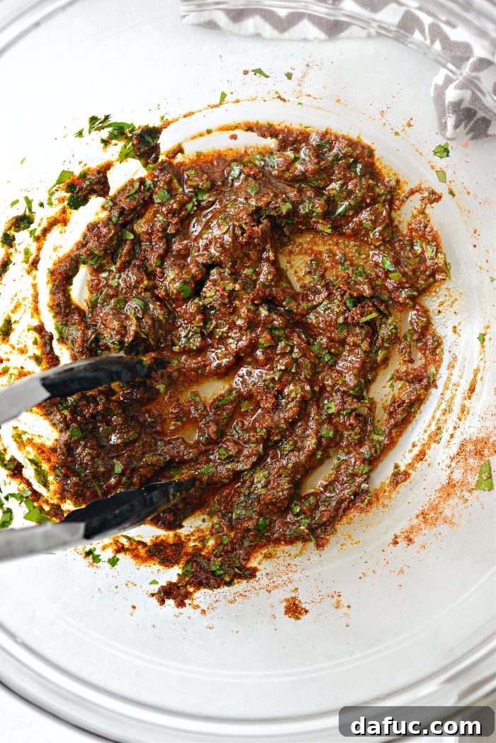 Smoky Chicken Elote Bowls 12 Stirring chicken marinade ingredients together