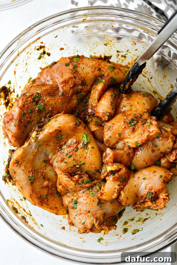 Smoky Chicken Elote Bowls 13 Adding chicken to the marinade and tossing to coat