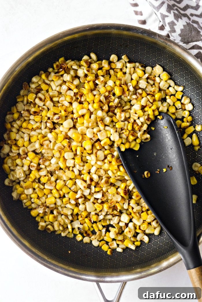 Smoky Chicken Elote Bowls 5 charred corn kernels in a skillet