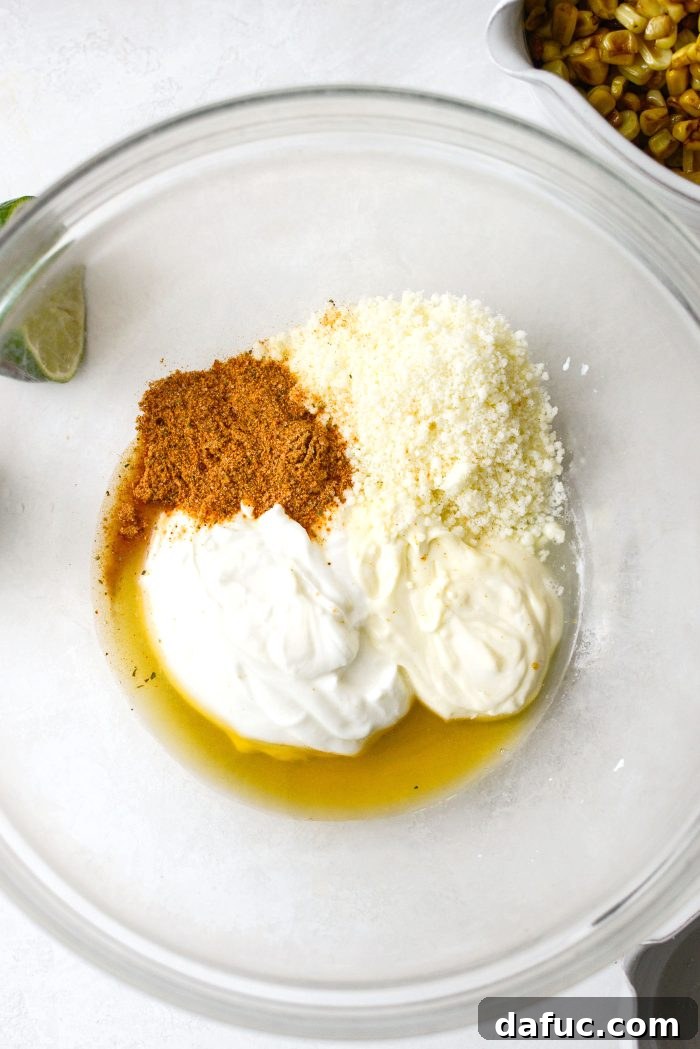 Smoky Chicken Elote Bowls 7 Ingredients for street corn salsa in a bowl: mayo, Greek yogurt, lime juice, honey, cotija, elote seasoning