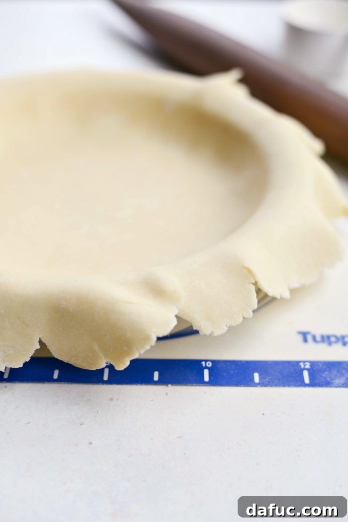Rolling out homemade pie dough for pumpkin pie