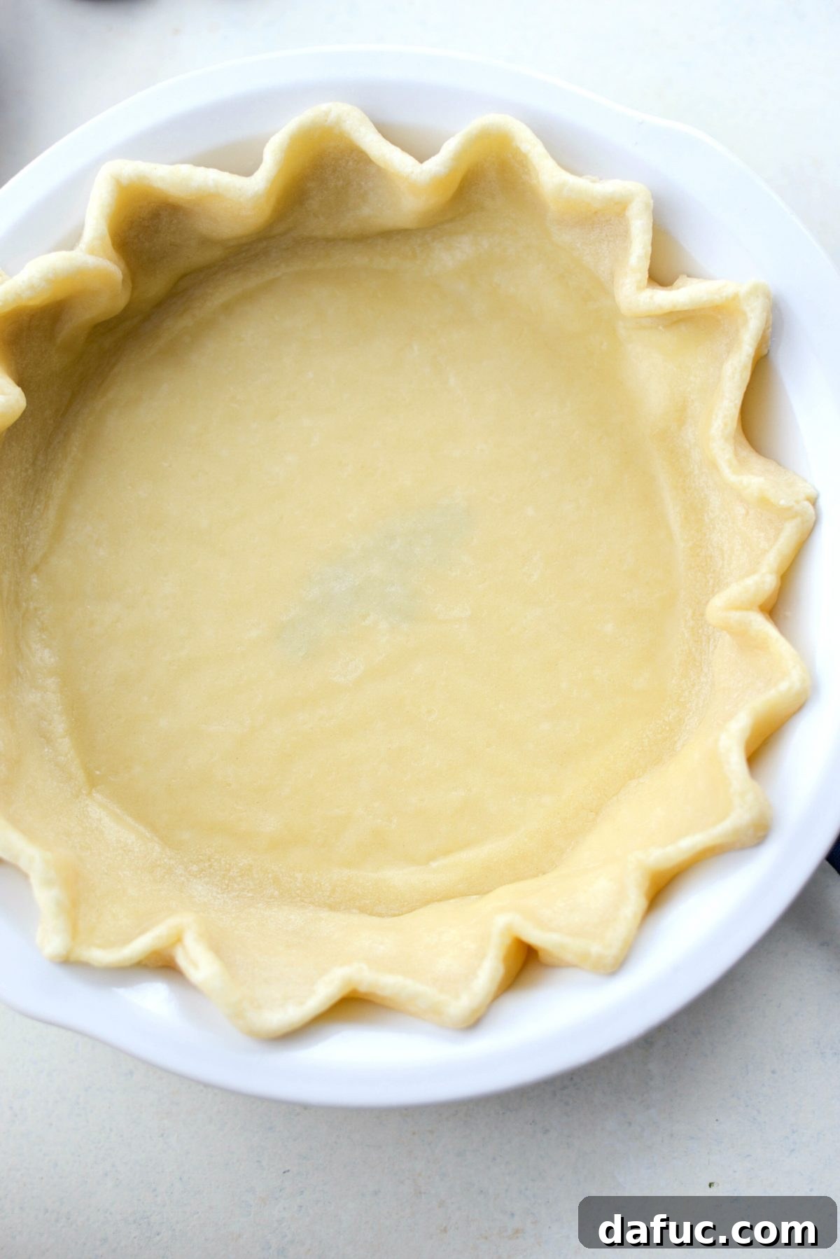 Partially baked golden-brown pie crust after blind baking