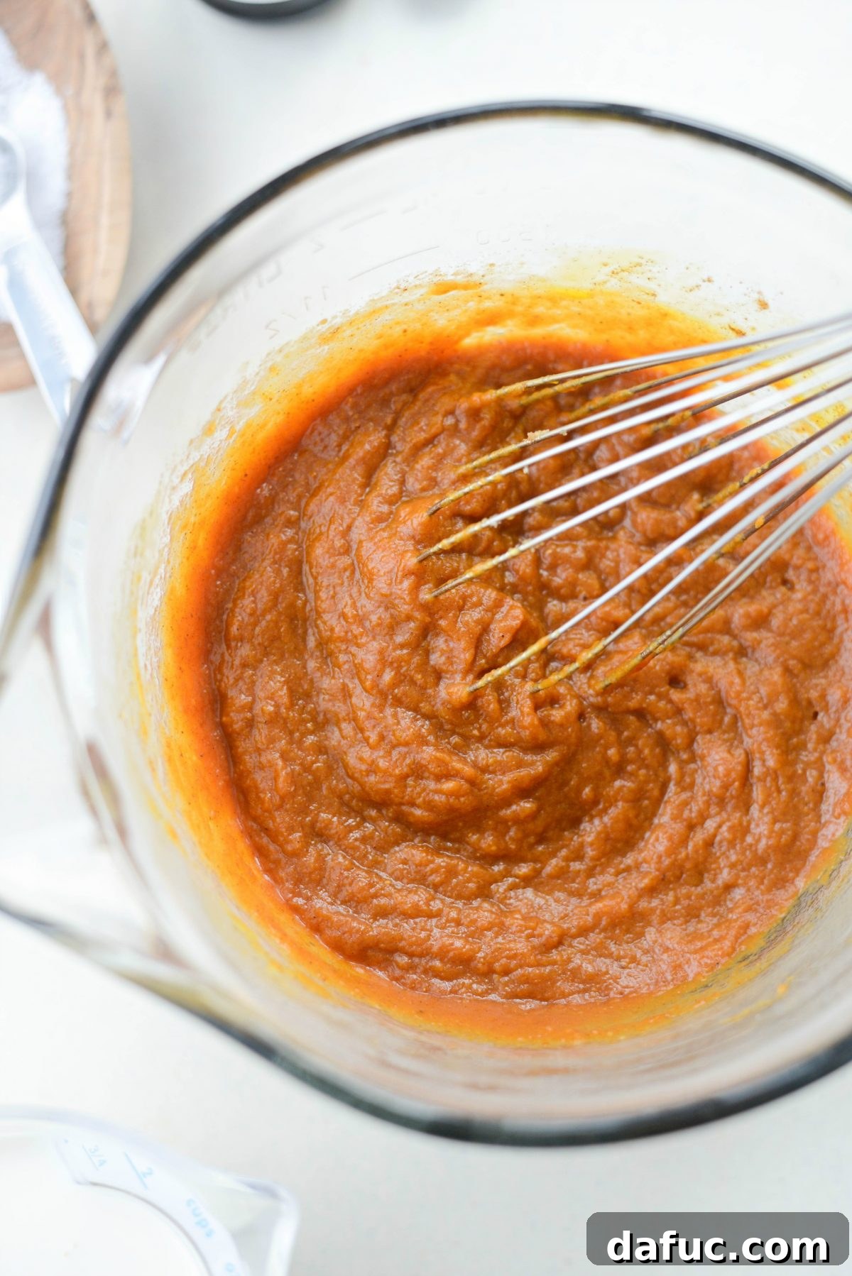Whisking pumpkin pie filling ingredients until thoroughly combined