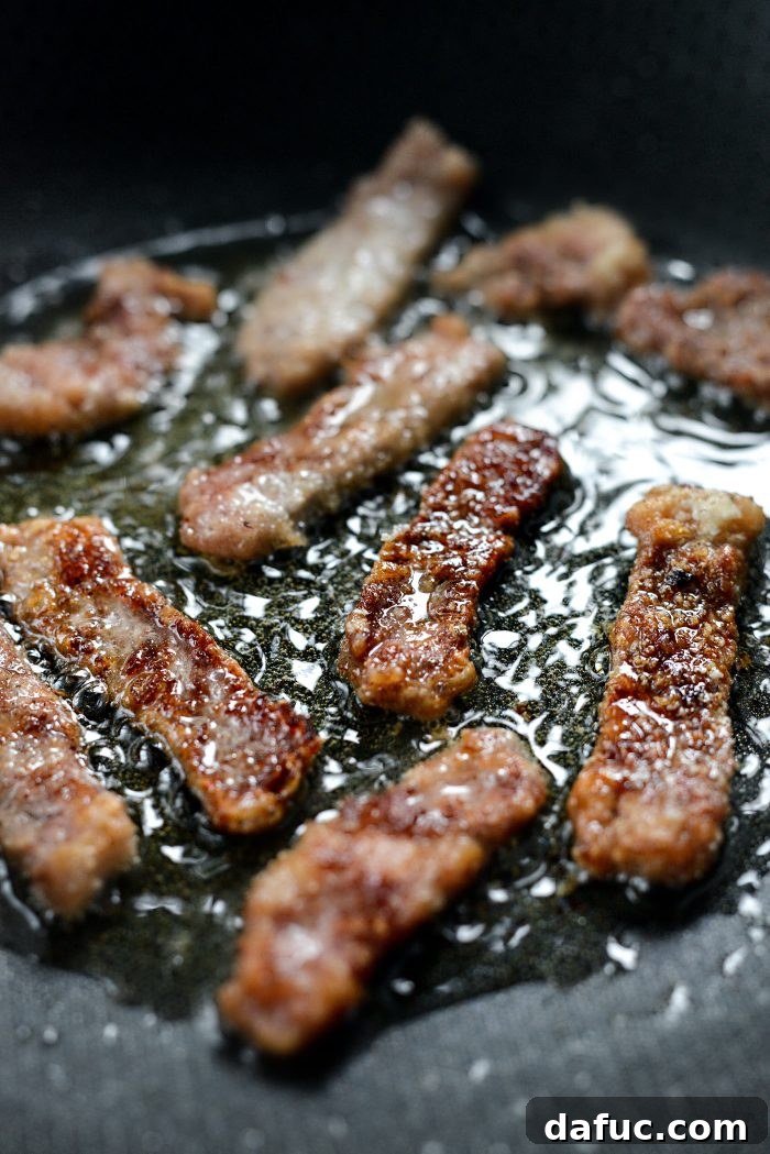 Spicy-Sweet Crispy Beef and Snap Peas 13 Crispy beef strips frying beautifully in a skillet, demonstrating the efficient batch cooking method.