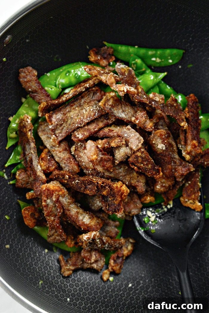Spicy-Sweet Crispy Beef and Snap Peas 18 All the crispy beef strips are added back into the skillet, joining the stir-fried snow peas and garlic.