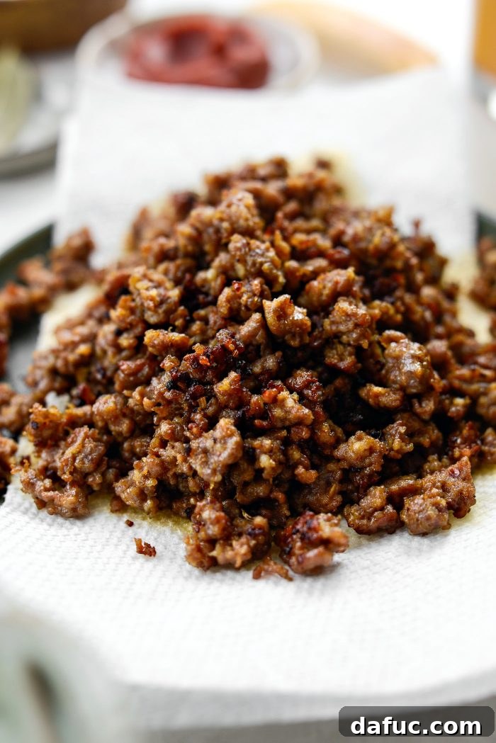 use a slotted spoon to transfer browned sausage to plate
