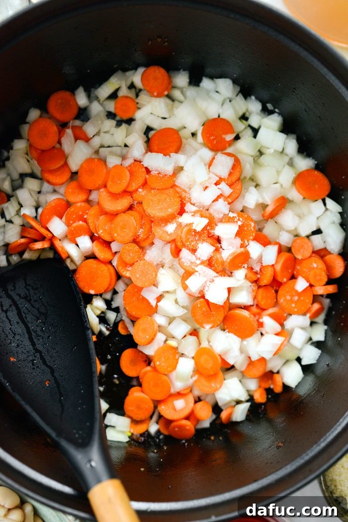 add onions and carrots with a pinch of salt to the pot