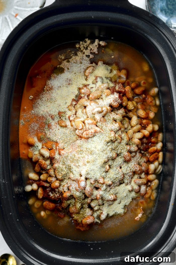 Adding spices and ranch seasoning to the slow cooker