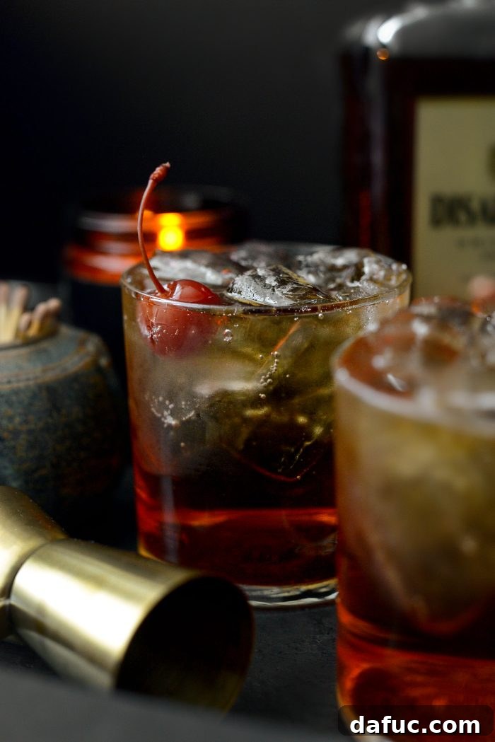 Spiced Amaretto Elixir 2 Classic Amaretto Ginger Cocktail served in a rocks glass with ice and a cherry