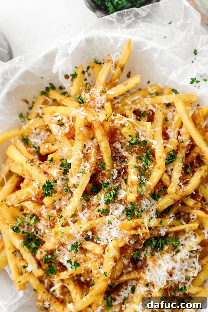 Decadent Truffle Parmesan Fries 2 Delicious Parmesan Truffle Fries served in a white bowl with a side of ketchup