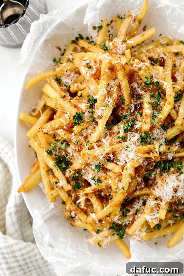 Decadent Truffle Parmesan Fries 13 Close-up shot of the finished Parmesan Truffle Fries with a fork picking one up