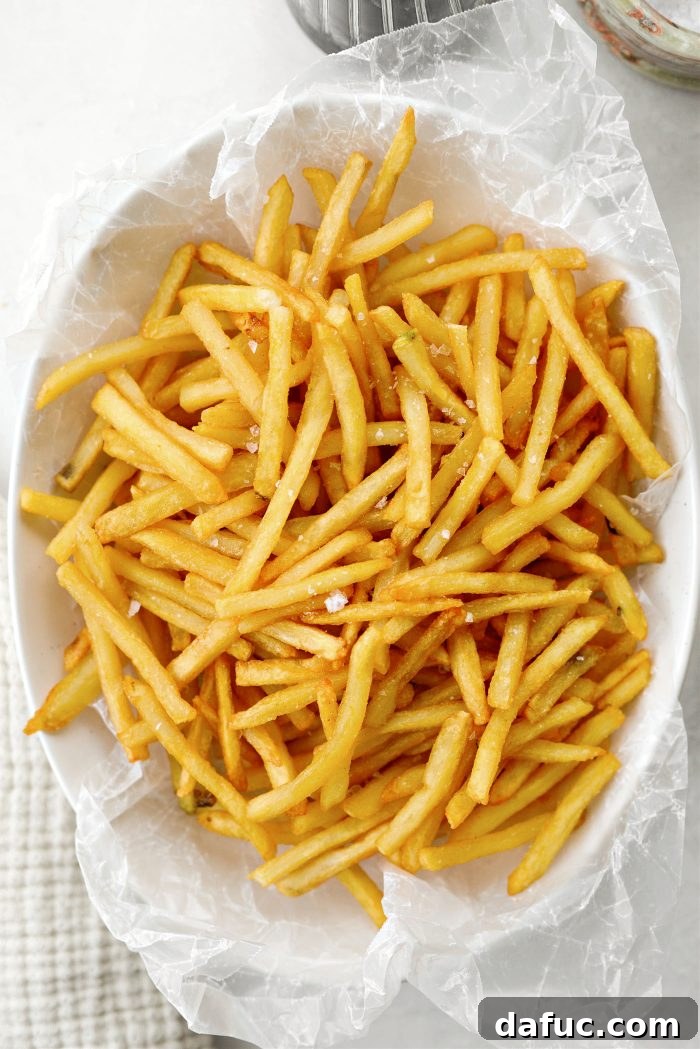 Decadent Truffle Parmesan Fries 8 Sprinkling flaky salt over truffle-infused French fries