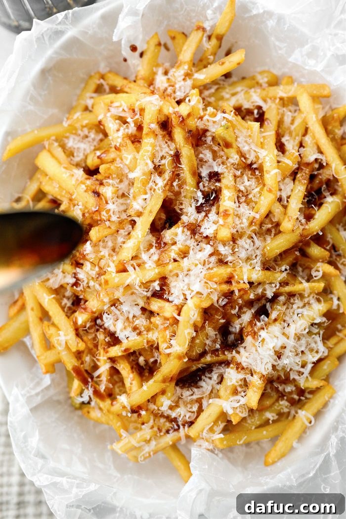 Decadent Truffle Parmesan Fries 10 Finishing touch: adding more freshly grated parmesan cheese to the fries