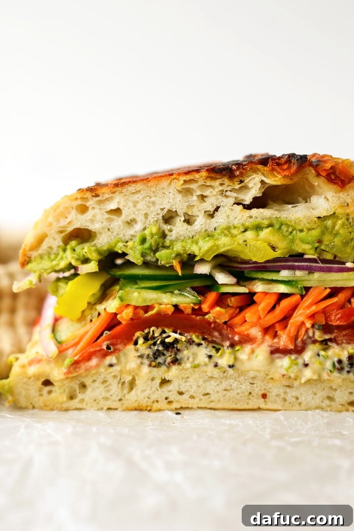 Vibrant Rainbow Stack 17 A sliced portion of the Rainbow Veggie Sandwich, ready to eat