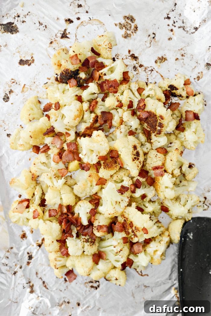 Crispy Bacon & Cheddar Roasted Cauliflower 11 Roasted cauliflower moved to the center of the pan, with bacon pieces added