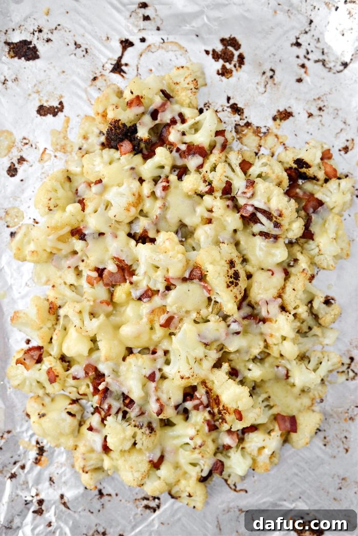 Crispy Bacon & Cheddar Roasted Cauliflower 13 Baking sheet returning to the oven to melt cheddar cheese