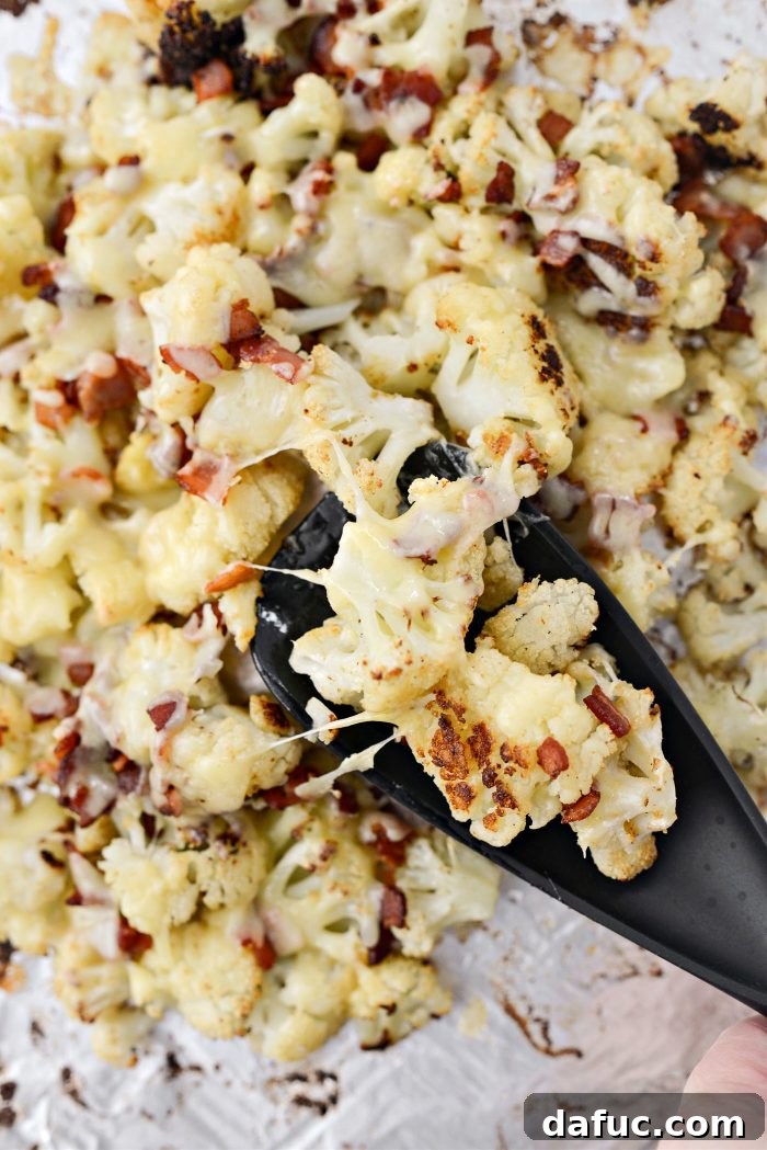 Crispy Bacon & Cheddar Roasted Cauliflower 14 Close-up of melted cheddar cheese over roasted cauliflower and bacon