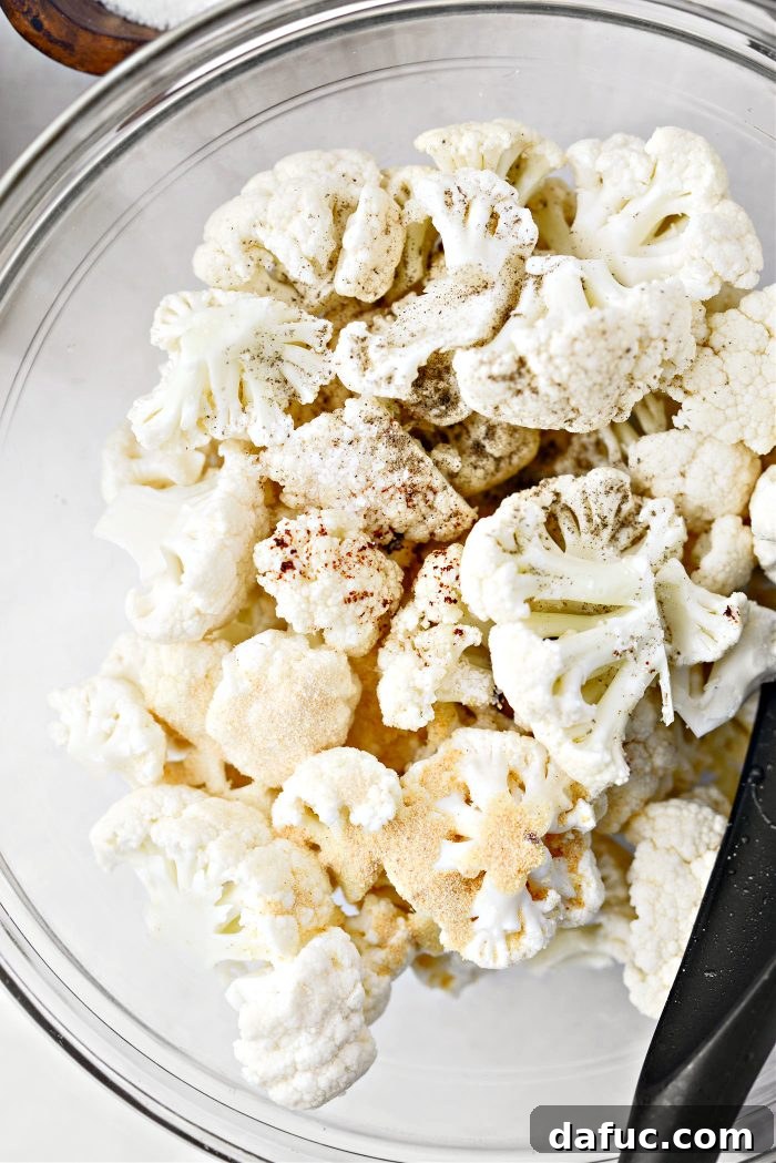 Crispy Bacon & Cheddar Roasted Cauliflower 7 Cauliflower florets in a bowl with bacon fat and seasonings