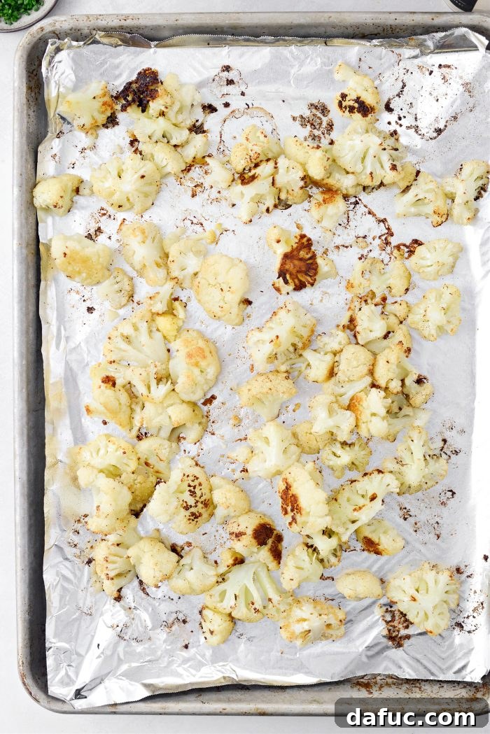 Crispy Bacon & Cheddar Roasted Cauliflower 10 Golden brown roasted cauliflower on a baking sheet