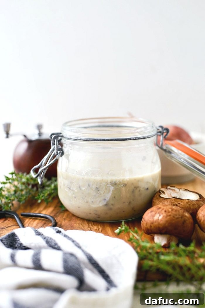 Delicious homemade condensed cream of mushroom soup in a bowl, garnished with fresh herbs.