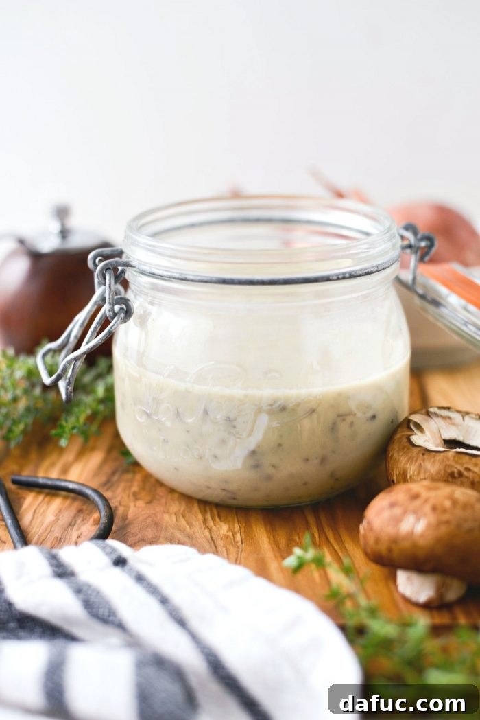 A jar of freshly made homemade condensed cream of mushroom soup, ready for storage.