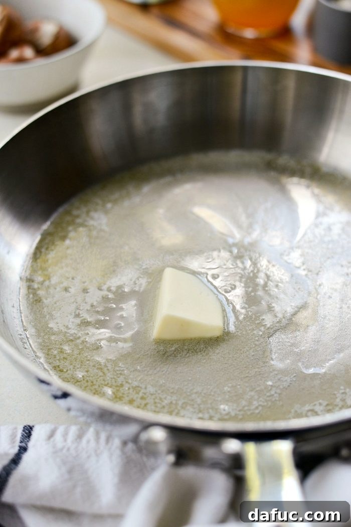 Melting butter in a skillet as the first step for making homemade mushroom soup.