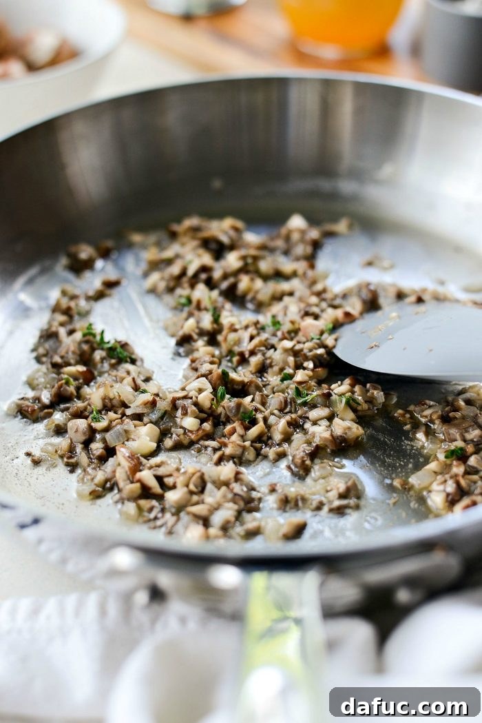 Cooking the mushrooms until they are tender and have released their moisture.