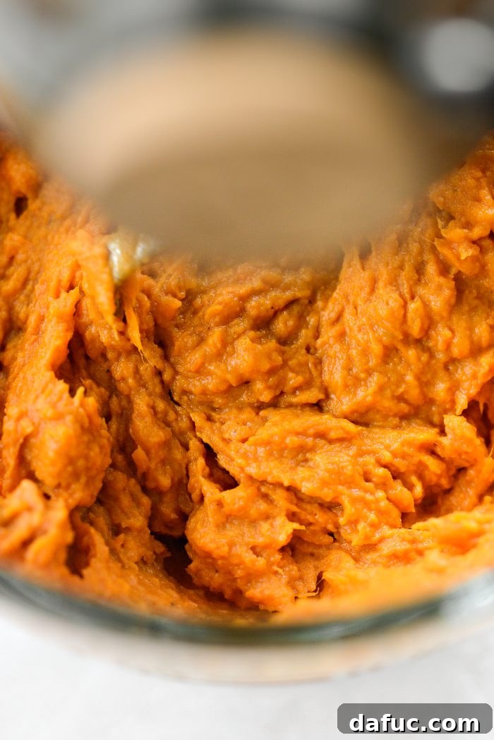 Mixing sweet potato casserole ingredients until fully combined
