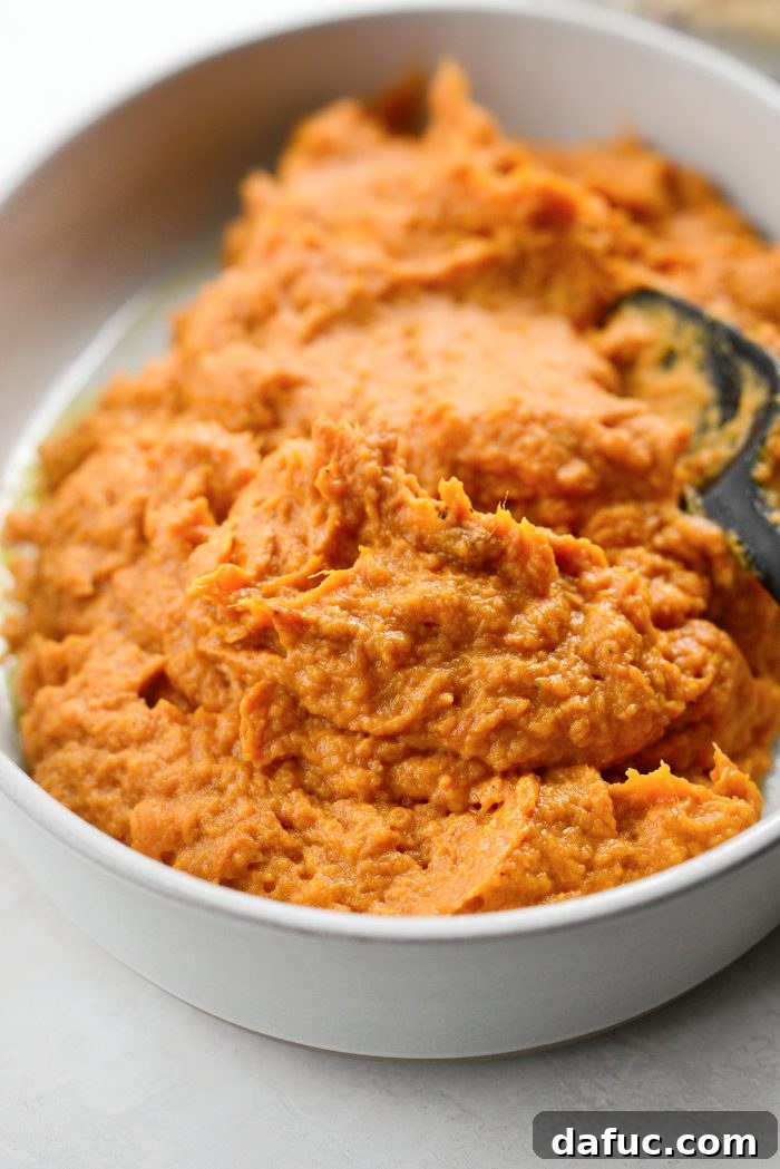 Transferring sweet potato mixture into a prepared casserole dish