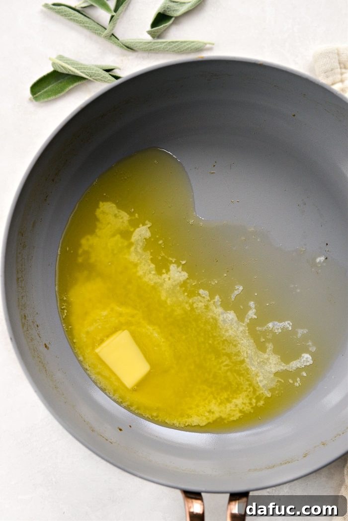 Melting unsalted butter in a skillet for sage brown butter