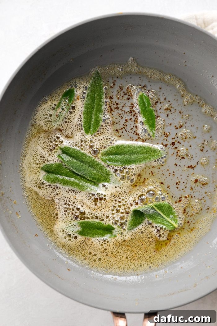 Adding fresh sage leaves to browned butter in a skillet